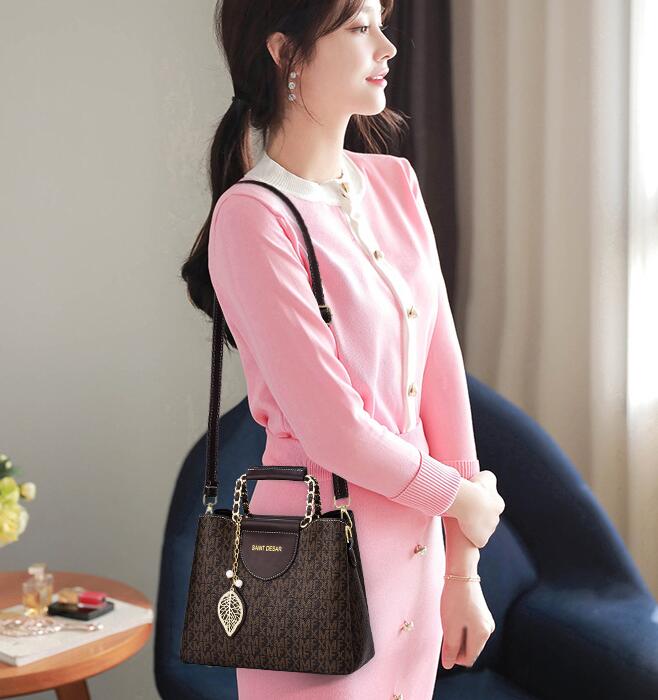 "Elegant woman in pink dress carrying a stylish handbag - Saint Desar bucket bag, durable nylon and cloth lining."