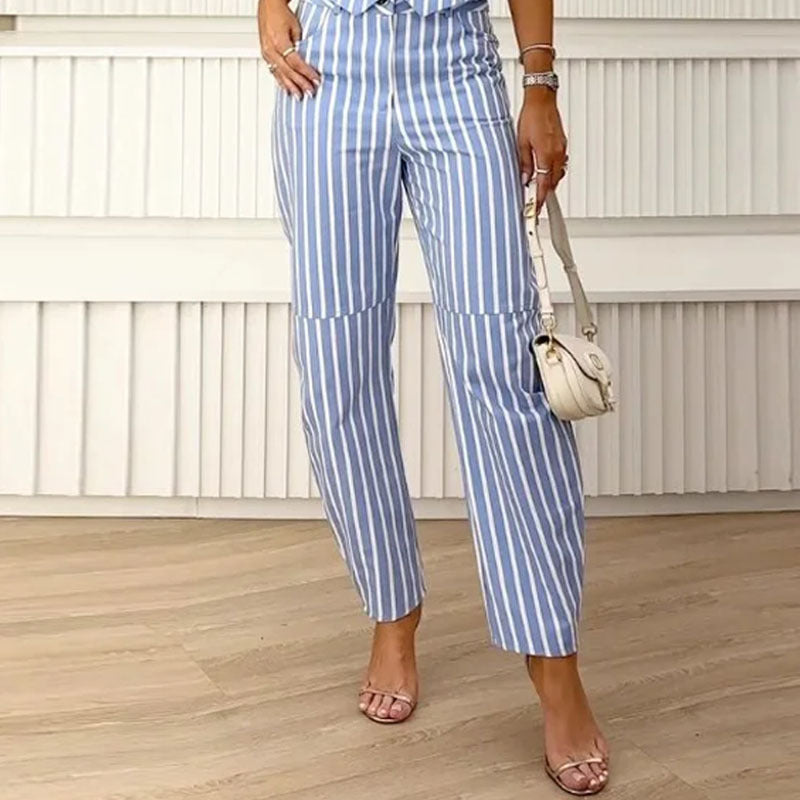 A woman wearing a sleeveless blue and white striped suit with a v-neck design.