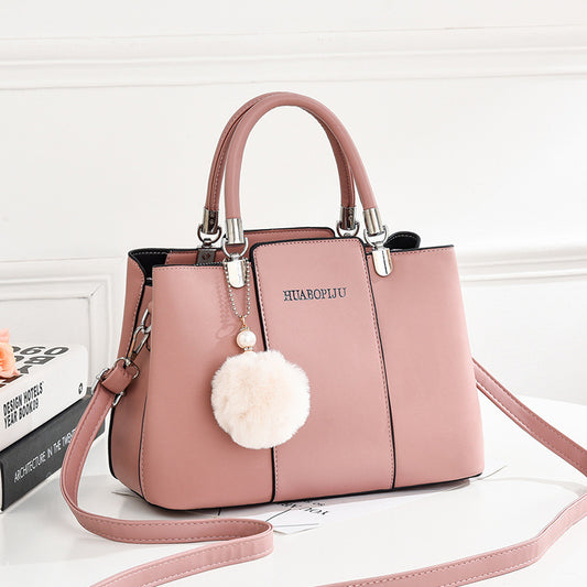  Stylish pink handbag by Huabopiju adorned with a cute pom pom on the strap, complete with a zipper pocket."