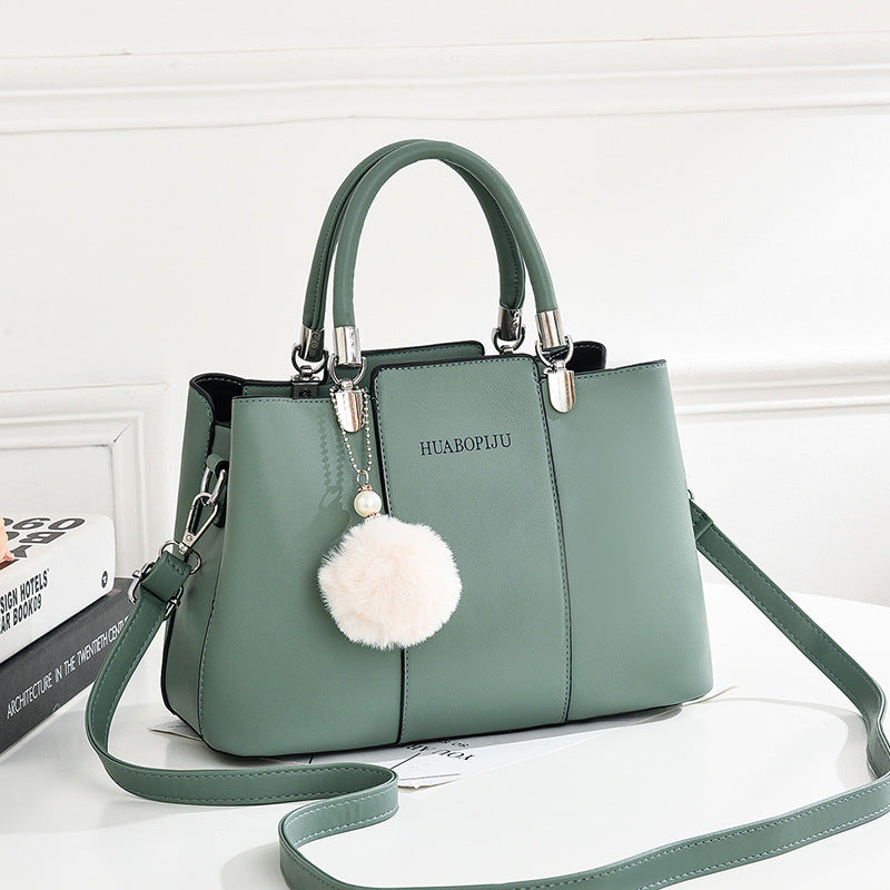  Stylish light green handbag by Huabopiju adorned with a cute pom pom on the strap, complete with a zipper pocket."