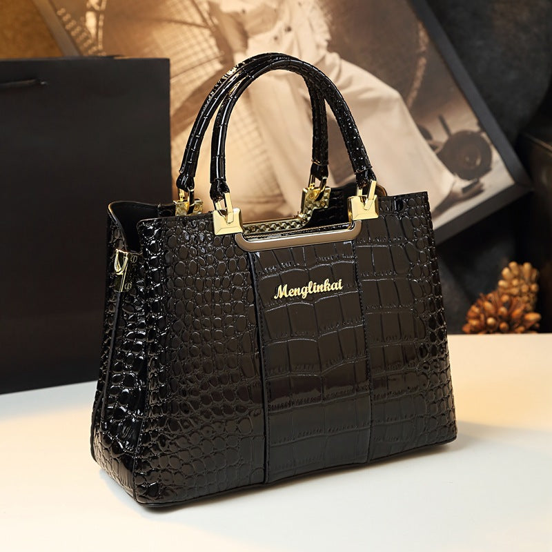 Elevate your fashion statement with a black Menglinkai snakeskin-like handbag, crafted from luxurious crocodile skin