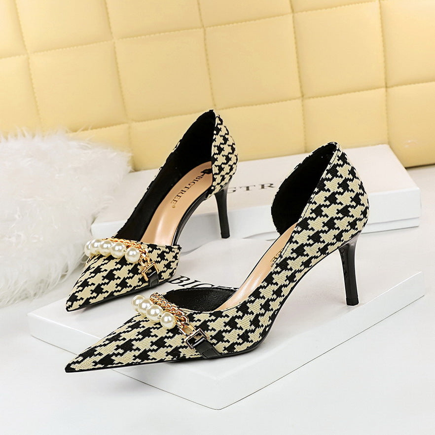 Women's black and cream patterned high heels with elegant pearls and intricate gold detailing. Perfect for a glamorous and sophisticated look.