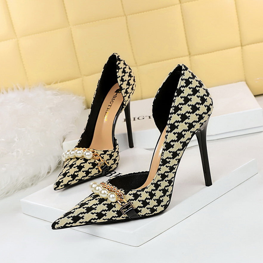 Women's black and cream patterned high heels with elegant pearls and intricate gold detailing. Perfect for a glamorous and sophisticated look.