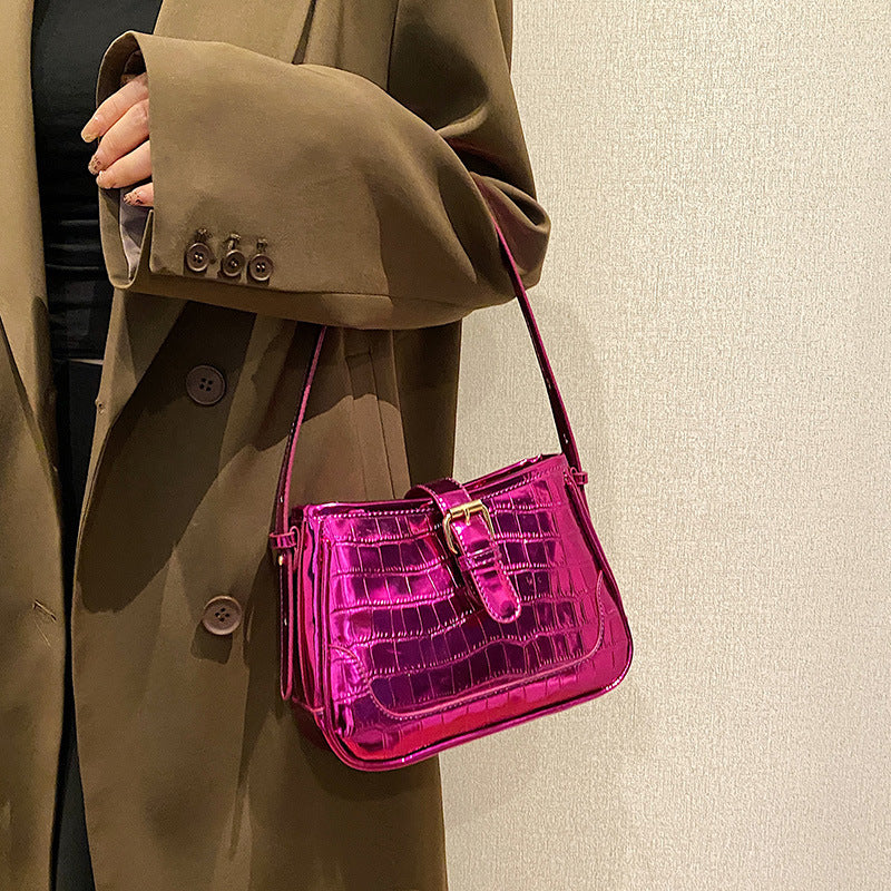 A red crocodile print bag.