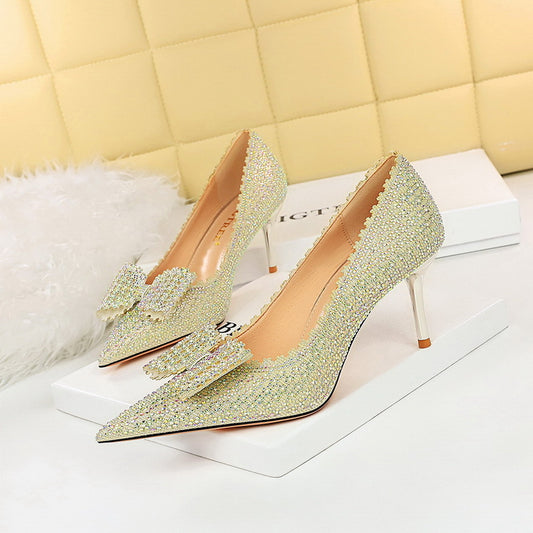 "Silver Rhinestone Heel adorned with a graceful bow, adding a touch of elegance and sparkle to your ensemble."