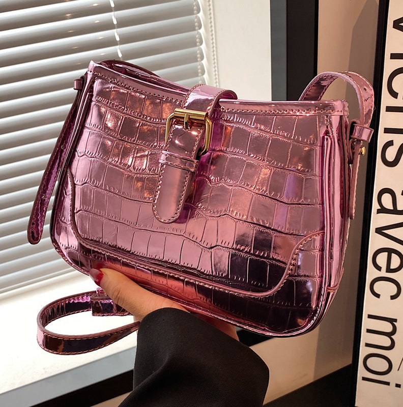 A pink crocodile print bag.