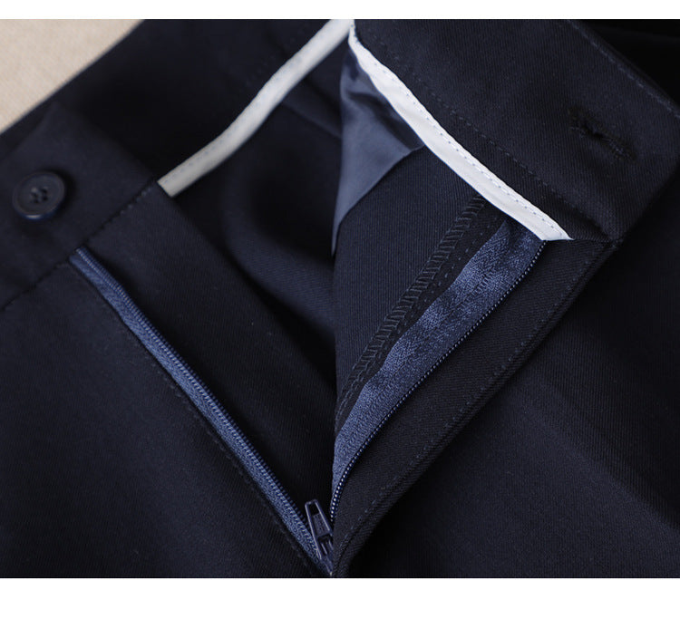 Navy suit jacket pocket, complemented by zipped navy pants