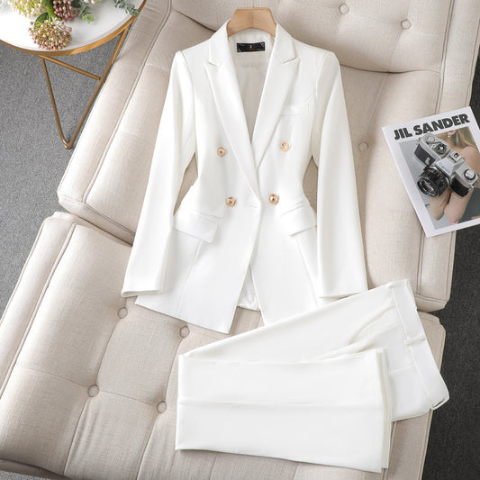 A white suit and pants neatly placed on a couch, creating a sophisticated and elegant look.