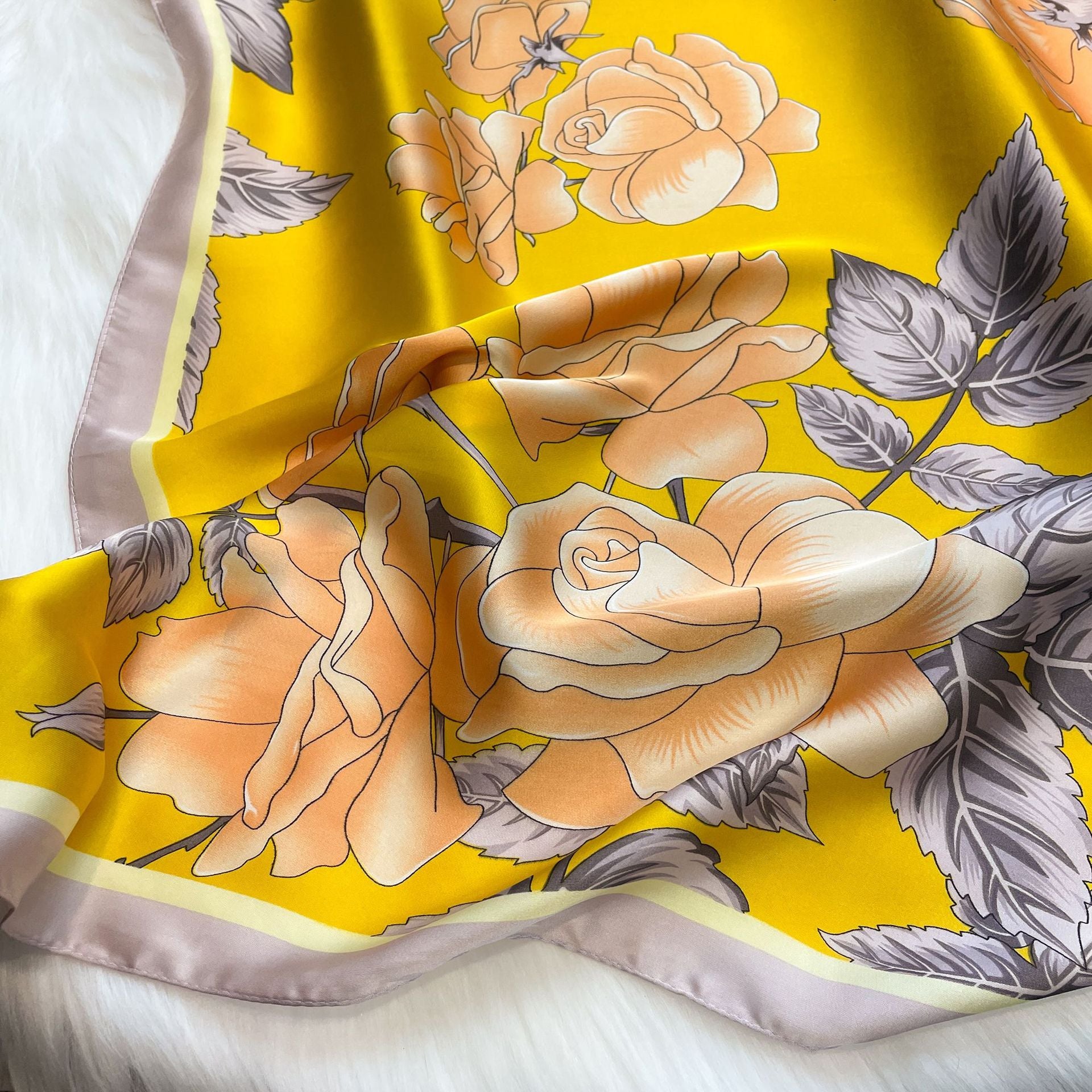 "Stylish yellow and gray floral scarf made of delicate gauze fabric with a lovely flower design."