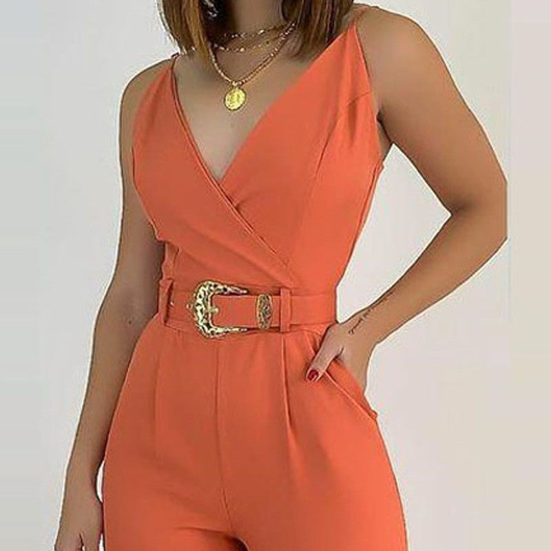 An elegant lady in an orange jumpsuit, accentuated by a stylish belt, radiating sophistication and grace.