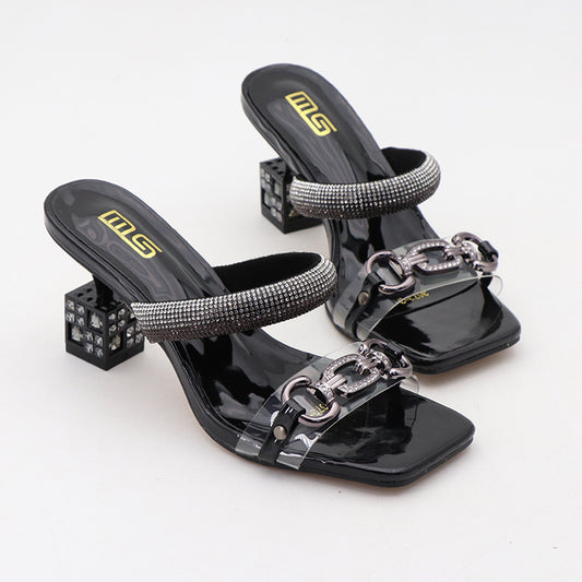 A pair of black sandals with rhinestones on them. Silver chain belt on square toe. Block heel with crystals inside.