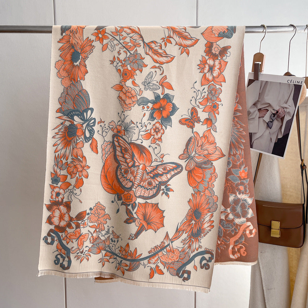 An orange floral print cashmere scarf with butterflies stands gracefully beside a car, exuding elegance and style.