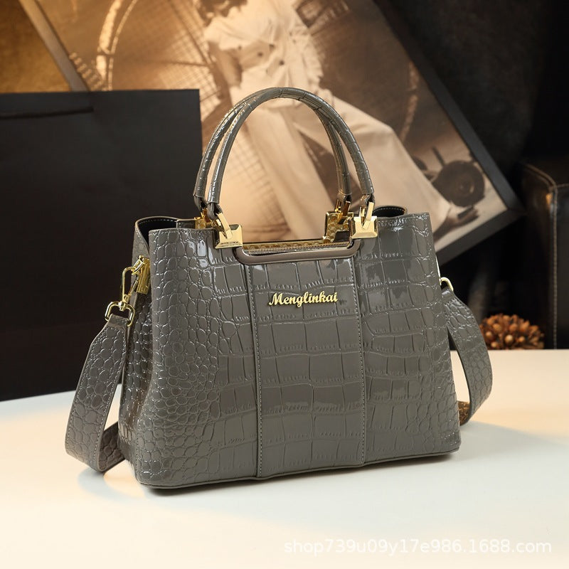 Elevate your fashion statement with a grey Menglinkai snakeskin-like handbag, crafted from luxurious crocodile skin