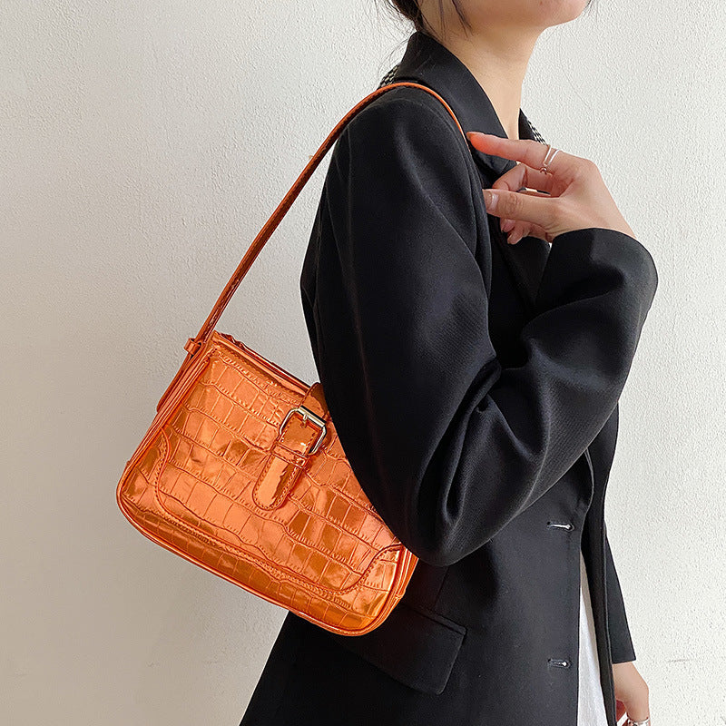 An orange crocodile print bag.