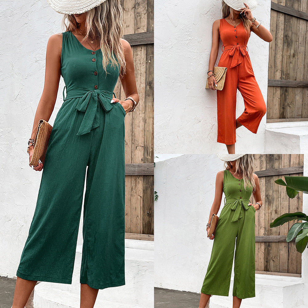 Fashionable women's summer jumpsuit with wide leg pants, sleeveless v-neck, and buttoned closure.